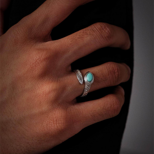 Close-up of a model's hand wearing the feather wrap ring, showcasing the chevron texture on the silver.