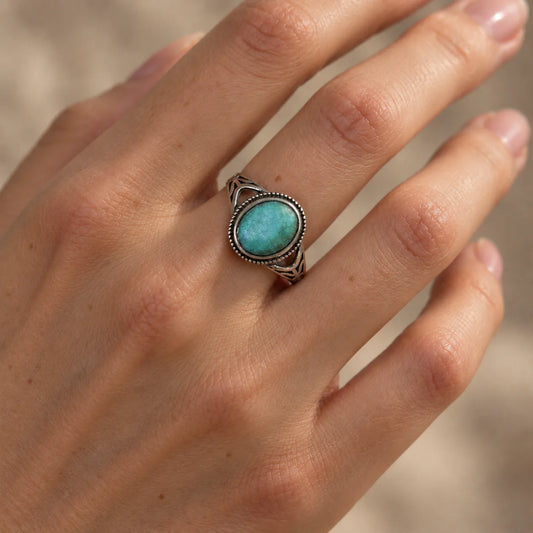 Nomad's Shield natural turquoise ring — worn close-up against dark background