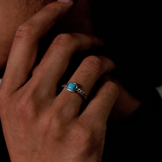 Close-up of a model wearing the Rational Link ring, showcasing the architectural chain band.