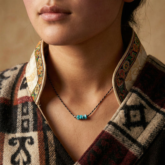 Close-up of a model wearing the Silent Pulse turquoise choker, ideal for meditation and spiritual grounding.