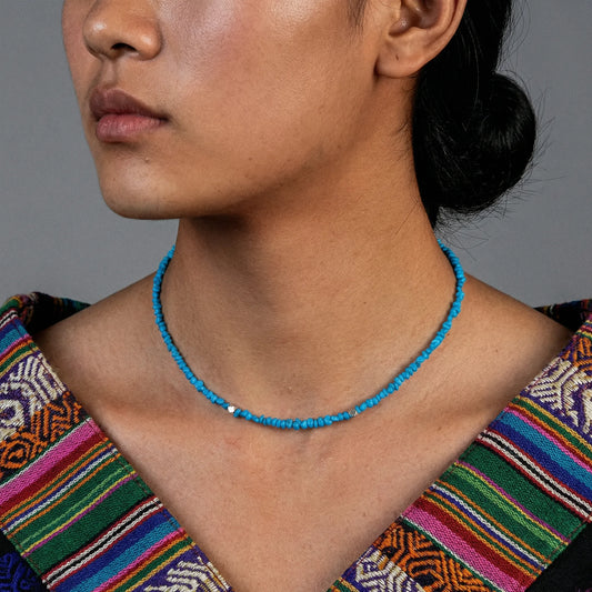 Close-up of a model wearing the Quiet Current turquoise choker for spiritual healing and daily style.