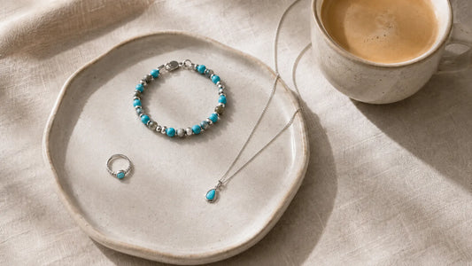 A small tray holding three turquoise and silver jewelry pieces, the starter set for a capsule wardrobe.