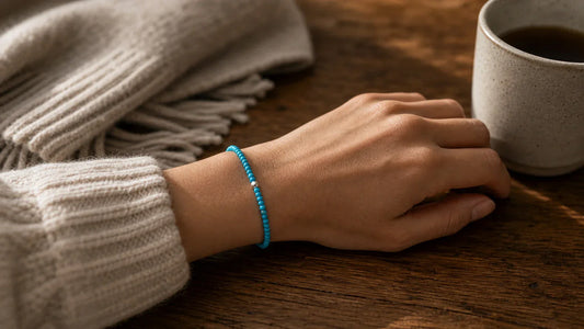 A turquoise December birthstone bracelet worn on the wrist as a tactile everyday keepsake.