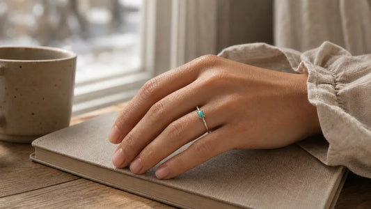 A turquoise December birthstone ring worn on a woman's hand as a quiet milestone keepsake.