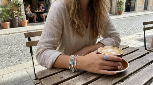 A woman wearing high-end turquoise jewelry, showing how natural stone, silverwork, and everyday wear influence turquoise value.
