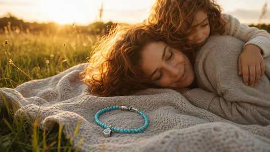 A busy mother finding a moment of peace in nature with her child, accompanied by a calming Tibetan turquoise bracelet—a truly meaningful gift for busy moms.