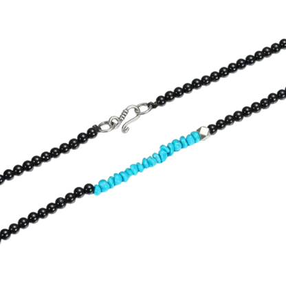 Detailed view of the handcrafted sterling silver bead and raw Tibetan turquoise chips on the Quiet Dawn necklace.