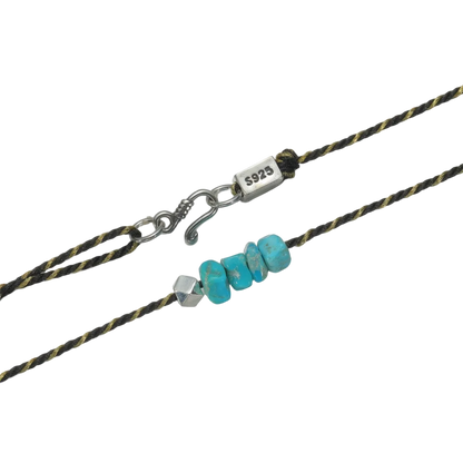 Detailed view of the handcrafted geometric 925 silver bead and the raw Tibetan turquoise chips.