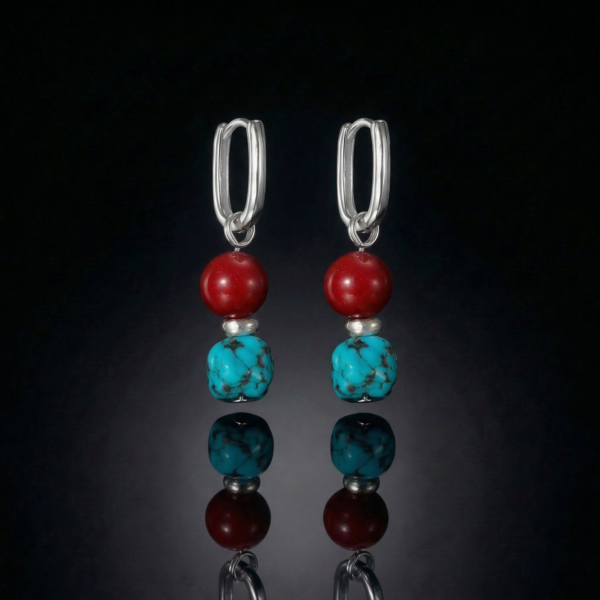 The Abundance Drops featuring natural Tibetan turquoise, deep red beads, and modern U-shaped sterling silver hoops.