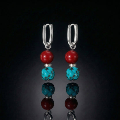 The Abundance Drops featuring natural Tibetan turquoise, deep red beads, and modern U-shaped sterling silver hoops.