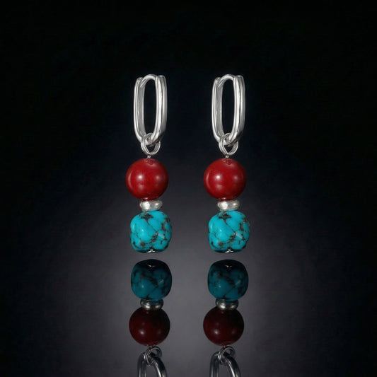 The Abundance Drops featuring natural Tibetan turquoise, deep red beads, and modern U-shaped sterling silver hoops.