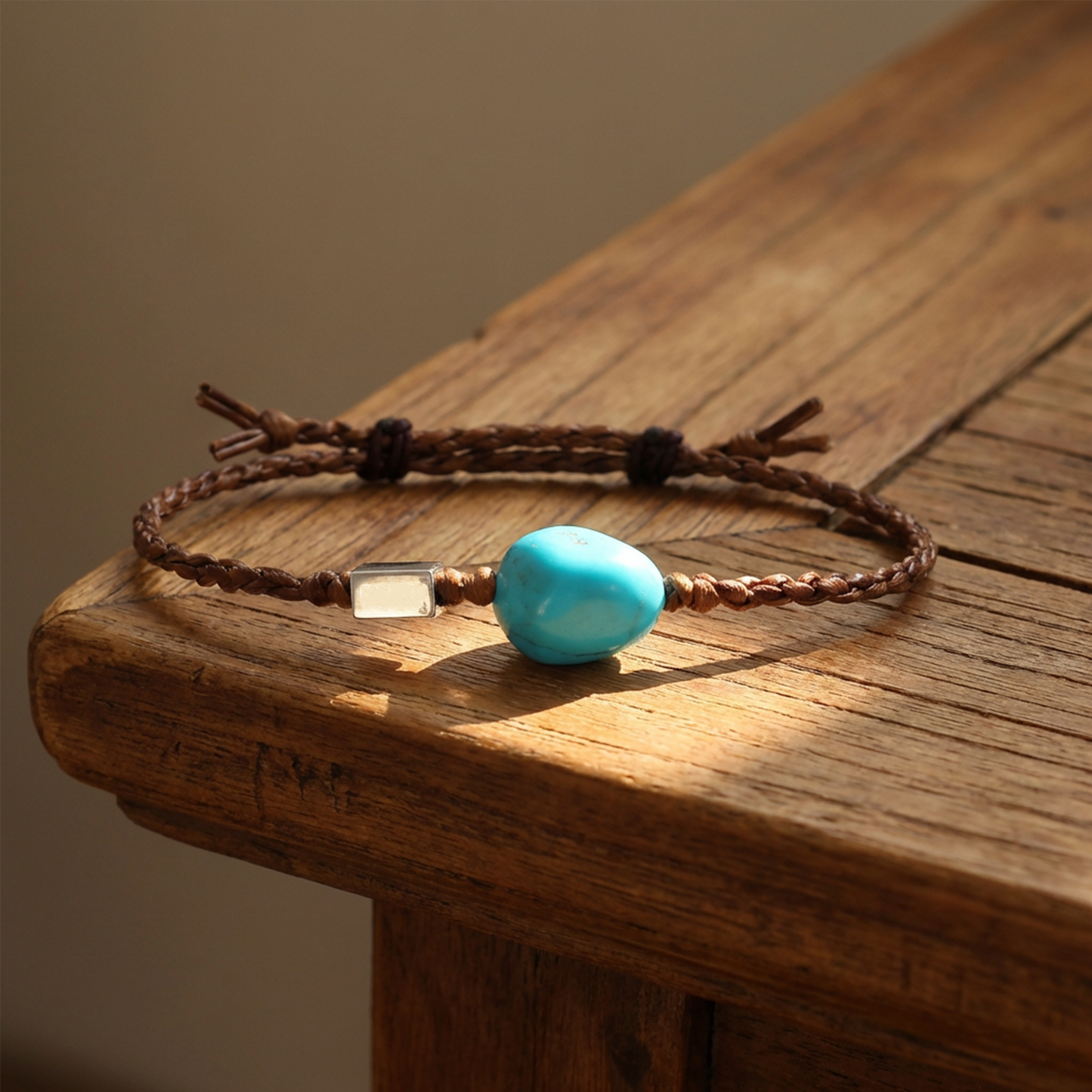 The Anchor Bracelet displayed on a rustic wooden table in natural sunlight, reflecting Himalayan heritage.