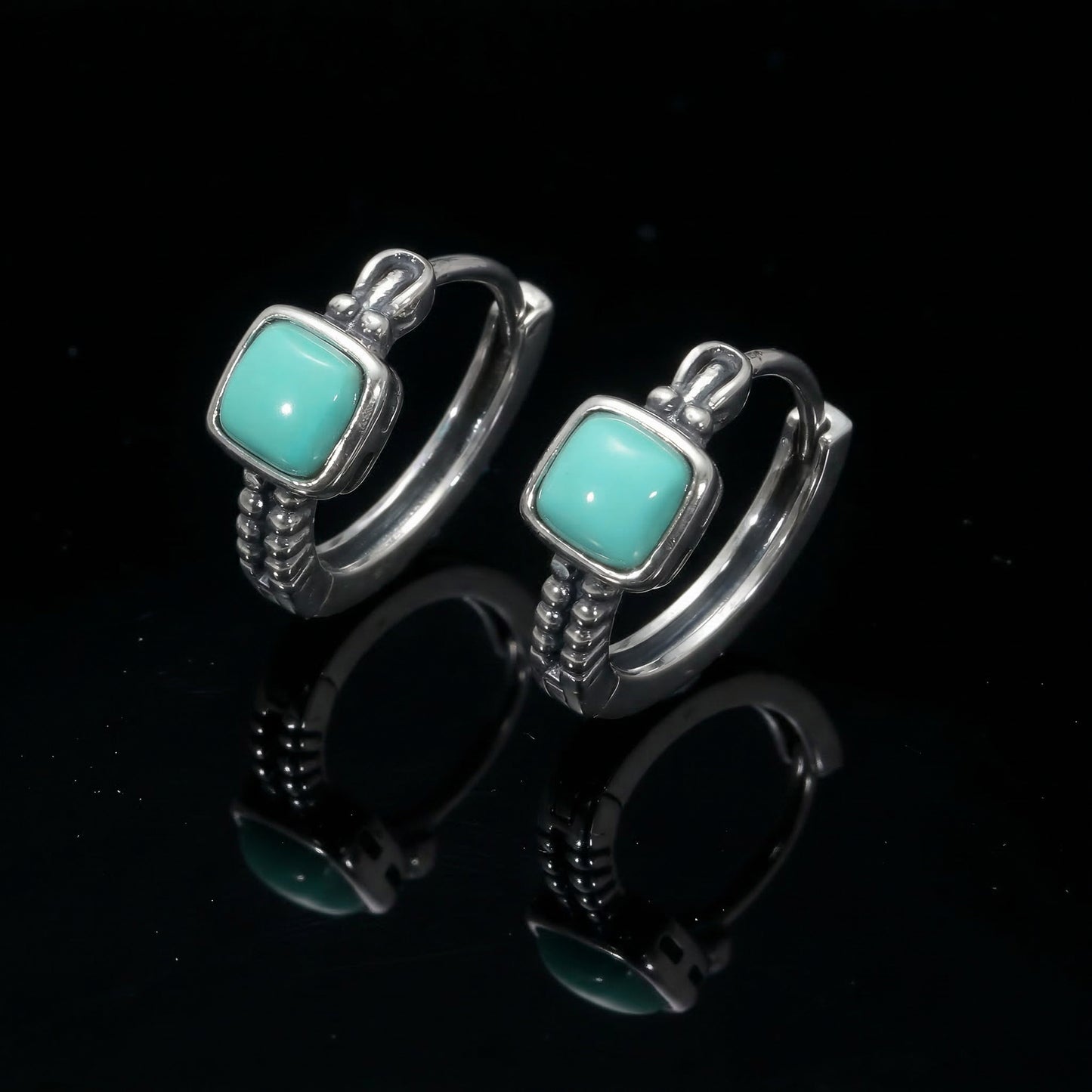 The Axiom Hoops featuring square-cut Tibetan turquoise and architectural sterling silver textures.