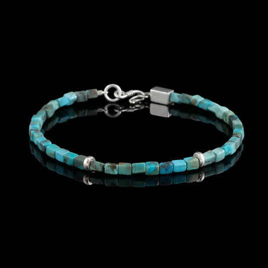 The Clarity Bracelet featuring precision-cut Tibetan turquoise cubes and minimalist sterling silver spacers.