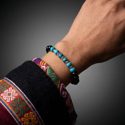 Perspective view of the Eclipse bracelet on a wrist against a dark, moody background.