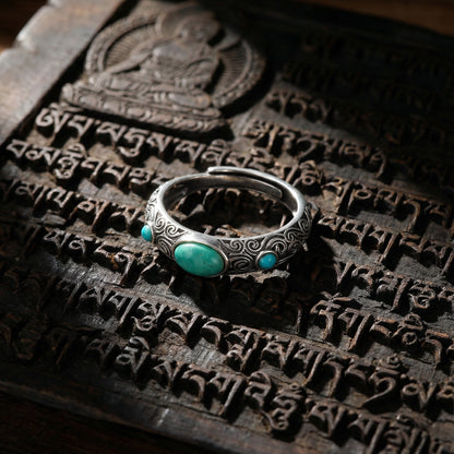 The Eternal Scroll Ring displayed on an ancient carved wood scripture block, reflecting temple heritage.