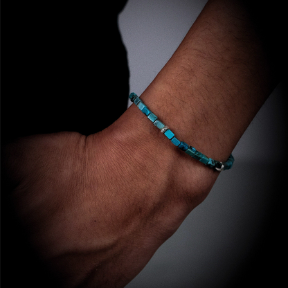 Side view of the natural turquoise cube bracelet on a wrist, showcasing its sharp geometric lines.