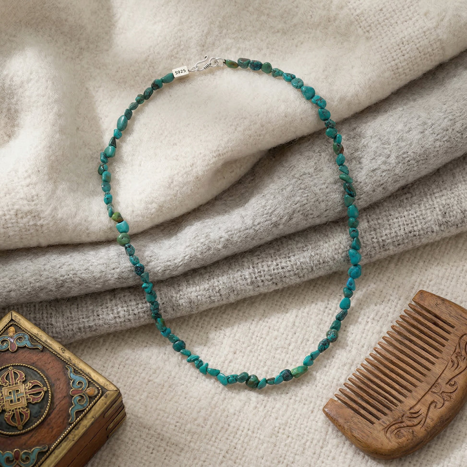 The Plateau Stream necklace displayed with a traditional wooden comb and box, reflecting Himalayan heritage.
