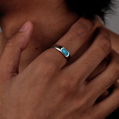 Close-up of a model's hand wearing the horizontal turquoise ring, symbolizing focused vision.