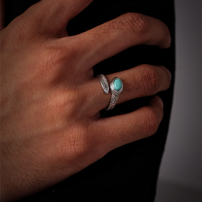 A model wearing the feather ring, highlighting the elegant way the silver curves around the finger.