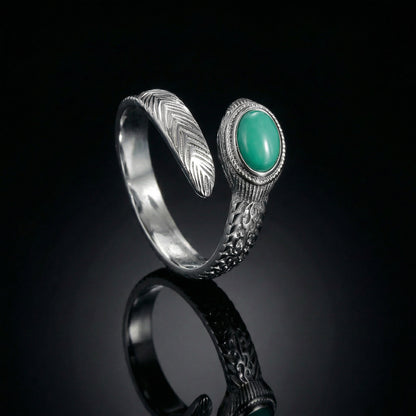 The Insight Feather Ring featuring a detailed sterling silver feather wrap design and turquoise stone.