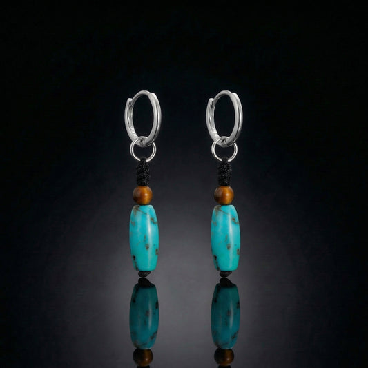 The Knot Drops featuring hand-woven black cords, brown accent beads, and Tibetan turquoise cylinders.