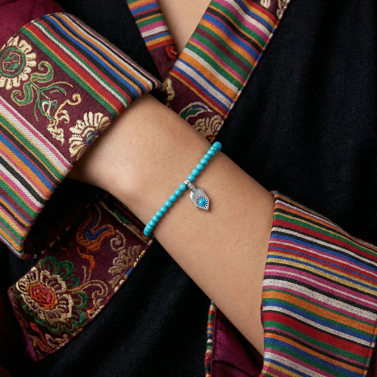 Side view of the Sun Shield turquoise bracelet on a wrist, showcasing its lightweight and layerable design.