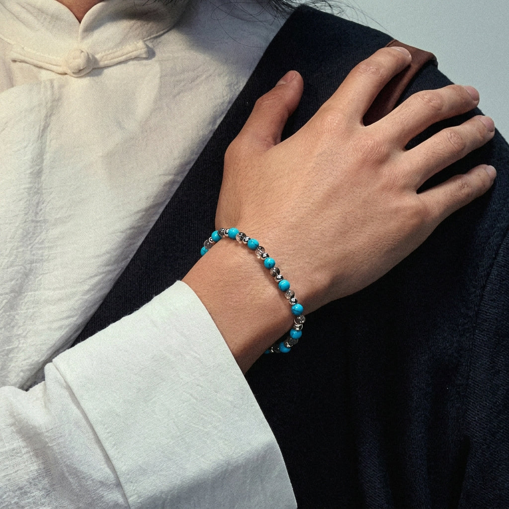 Close up of a man's wrist wearing luxury mens beaded bracelets crafted with genuine Tibetan turquoise.