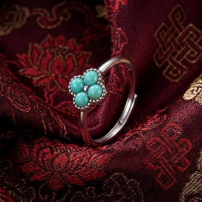 The Mandala Ring displayed on traditional red Tibetan silk, reflecting heritage and spiritual fulfillment.