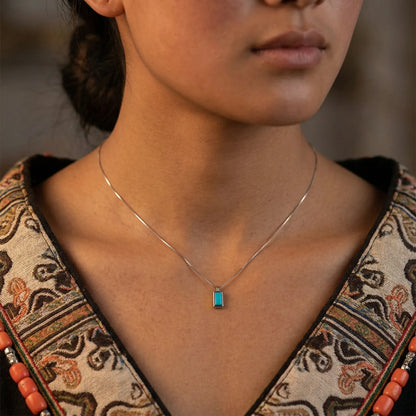 Front view of the Clarity Frame necklace on a model, showcasing its modern geometric design.