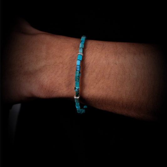 Close-up of a wrist wearing the Clarity Tibetan turquoise cube bracelet for focus and mental clarity.