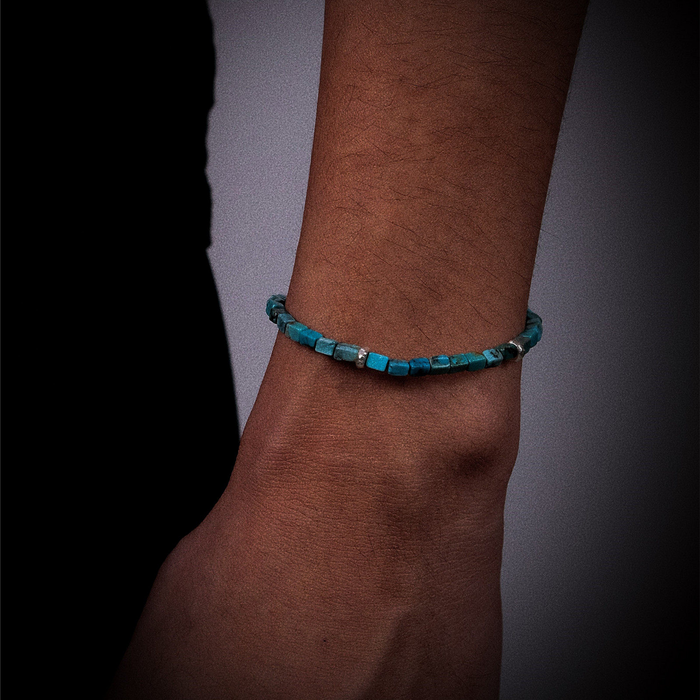 The Clarity turquoise bracelet worn on a model's wrist, reflecting a sophisticated and intellectual style.
