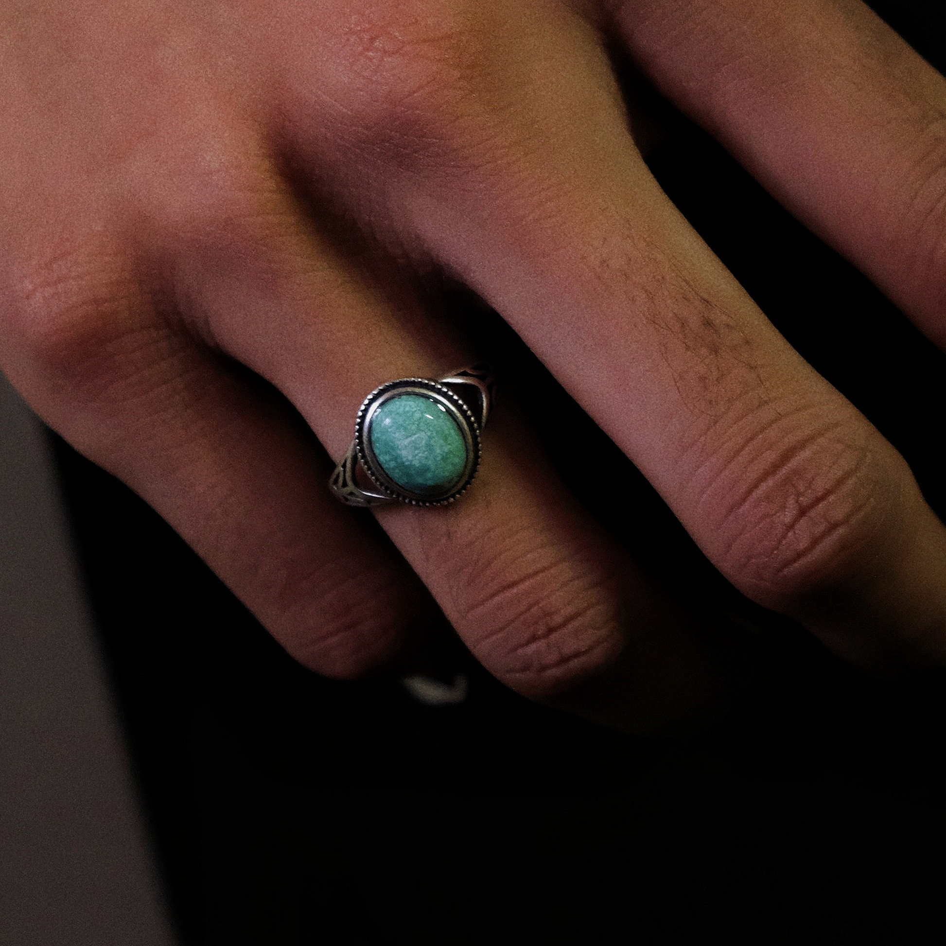 A model wearing the Nomad's Shield ring, highlighting its substantial yet airy silhouette.