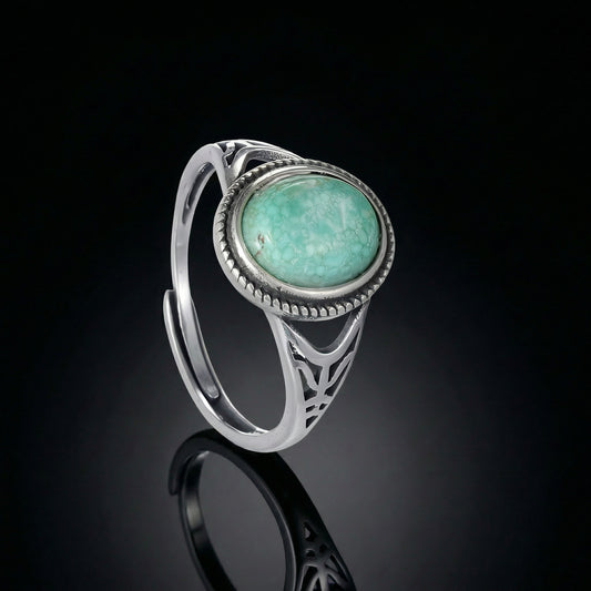 The Nomad's Shield Ring featuring an oval Tibetan turquoise and geometric openwork silver band.