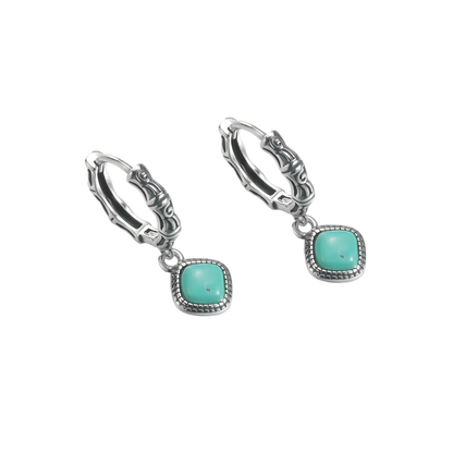 Angled view of the Sentinel Drops pair on a clean white background, showcasing the studded silver bezels.