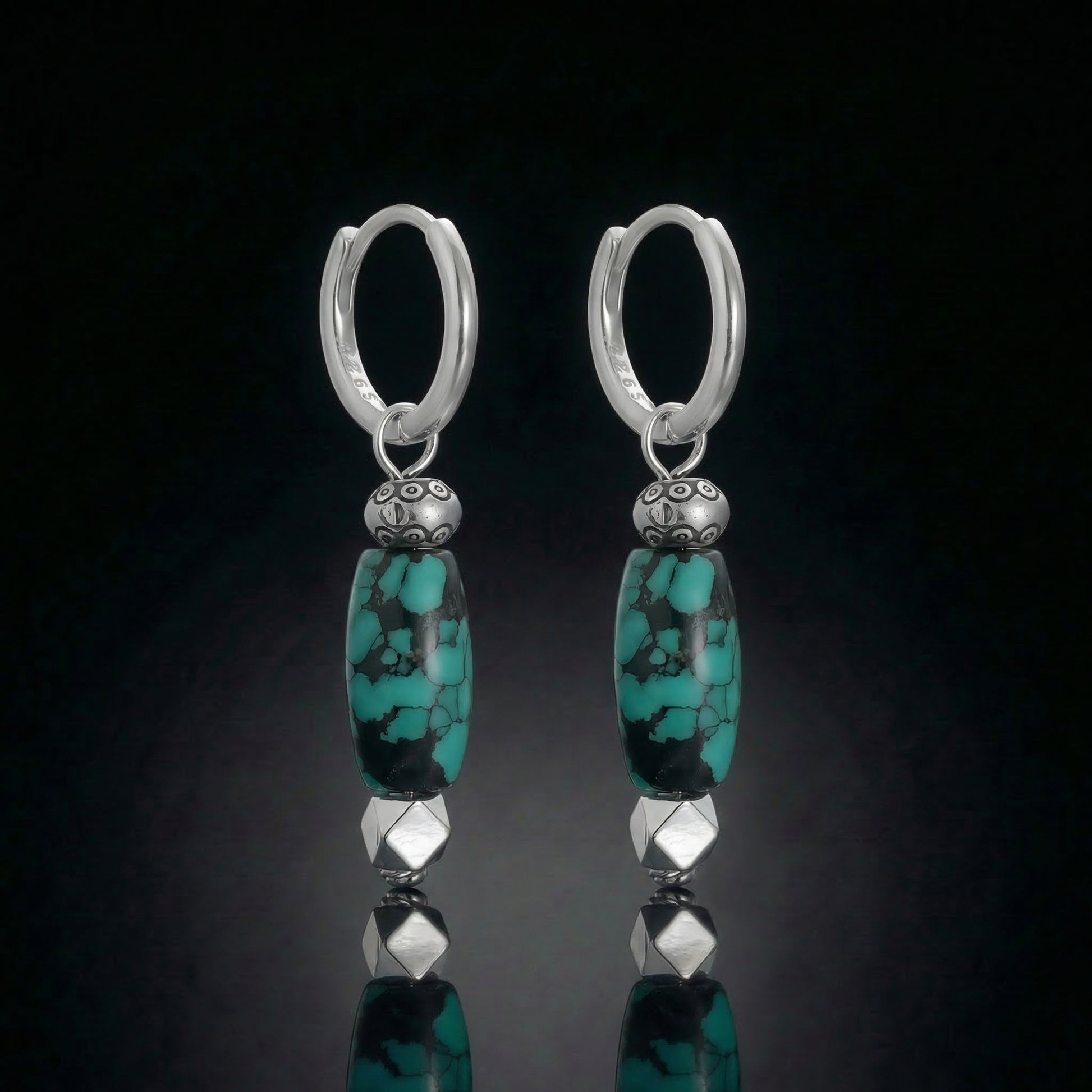 The Pillar Drops featuring elongated Tibetan turquoise cylinders and armored sterling silver hardware.