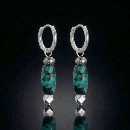 The Pillar Drops featuring elongated Tibetan turquoise cylinders and armored sterling silver hardware.
