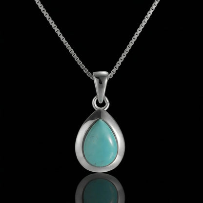 The Pure Drop Necklace featuring a teardrop-shaped Tibetan turquoise in a sleek 925 sterling silver bezel.