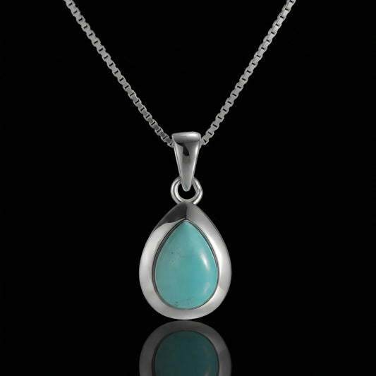 The Pure Drop Necklace featuring a teardrop-shaped Tibetan turquoise in a sleek 925 sterling silver bezel.
