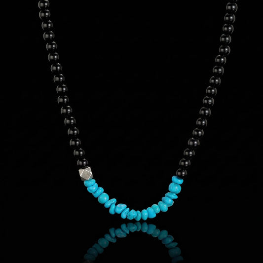 The Quiet Dawn Strand featuring dark grounding stones and a cluster of Tibetan turquoise chips.