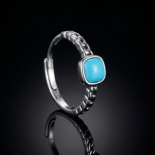 The Rational Link Ring with a cushion-cut Tibetan turquoise and silver Cuban link band.