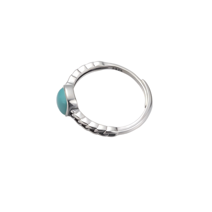 Side view of the cushion-cut turquoise and adjustable band on white background.