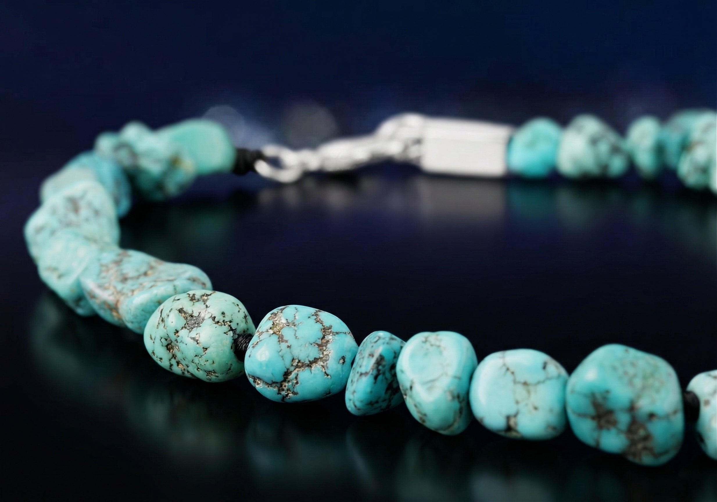A macro close-up of raw Tibetan turquoise beads on a deep navy background, illustrating "The Sediment of Hands" narrative. This handcrafted Himalayan turquoise artifact represents a grounding anchor for mindfulness and inner peace.