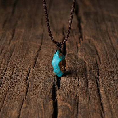 The Solitary Stone turquoise necklace resting on a natural wood surface, reflecting Himalayan heritage.