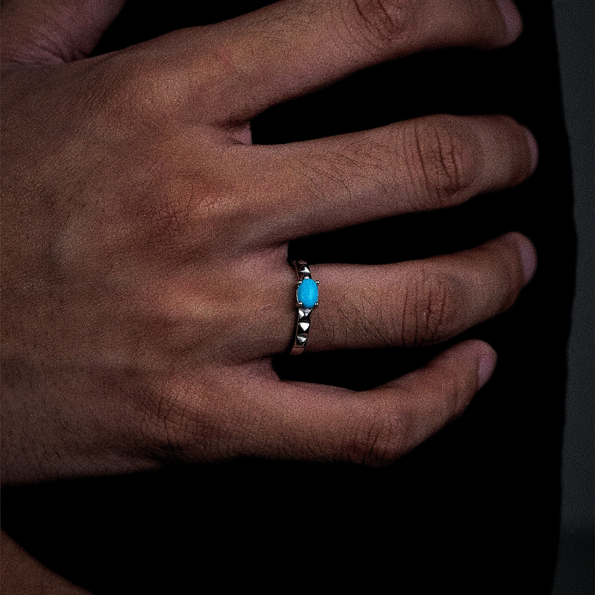 Perspective view of the Ridge turquoise ring on a finger, highlighting the crisp architectural silver lines.