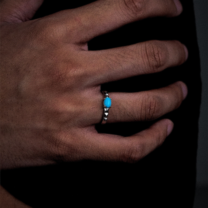 Perspective view of the Ridge turquoise ring on a finger, highlighting the crisp architectural silver lines.