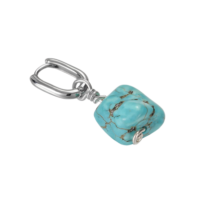 Detailed view of the organic brown matrix pattern on the Tibetan turquoise nugget and the 925 silver hoop clasp.