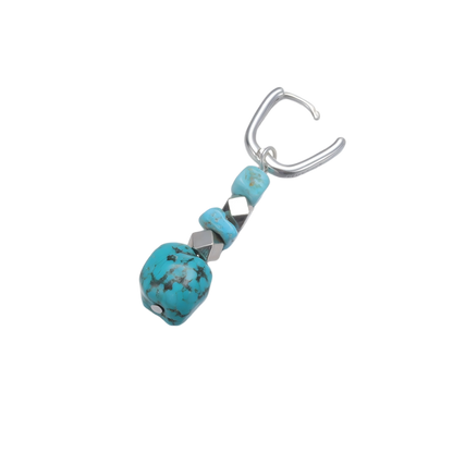 Detailed view of the U-shaped 925 sterling silver hoop, geometric spacers, and freeform Tibetan turquoise stone.