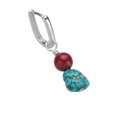 Detailed view of the U-shaped 925 sterling silver hoop, delicate spacer, and the contrasting Tibetan turquoise and red stones.