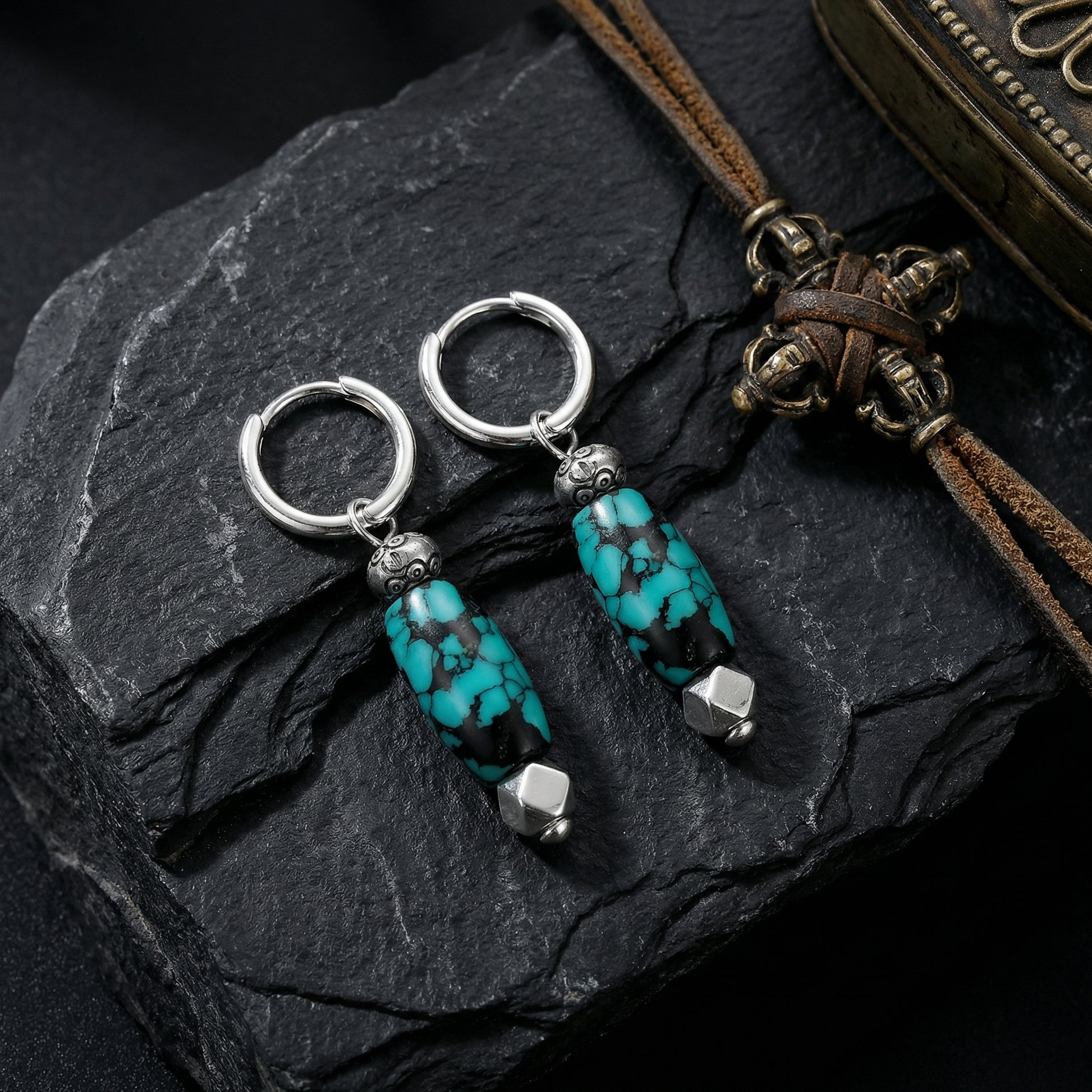 The Pillar Drops displayed on dark slate stone with traditional artifacts, reflecting Himalayan heritage and strength.